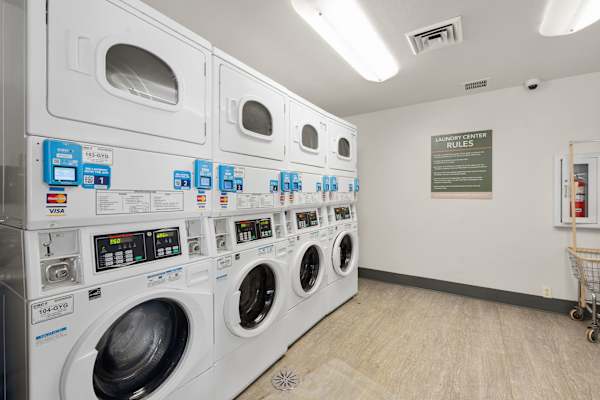 A row of washing machines in a laundromat. at AVIA Lofts on Parkway, Vancouver, WA